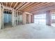 Unfinished basement with framed walls, doorways, and garage access at 772 Old Lathemtown And 776 Rd, Canton, GA 30115