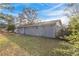Backyard view of a gray, single-story house under a blue sky at 1347 Peggy Nw Ln, Conyers, GA 30012