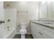 Bathroom with white tile, granite countertop vanity, and white toilet at 1347 Peggy Nw Ln, Conyers, GA 30012
