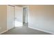 Empty bedroom with neutral walls, gray carpet, and closet doors at 1347 Peggy Nw Ln, Conyers, GA 30012