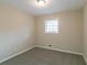 Vacant bedroom with neutral walls, gray carpet, and a window with blinds at 1347 Peggy Nw Ln, Conyers, GA 30012