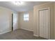 Empty bedroom featuring neutral walls, gray carpet, a closet, and a window at 1347 Peggy Nw Ln, Conyers, GA 30012