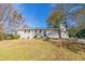 Charming single-story home with a grassy front yard and trees at 1347 Peggy Nw Ln, Conyers, GA 30012