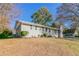 Inviting front yard with a driveway leading to a single-car garage at 1347 Peggy Nw Ln, Conyers, GA 30012