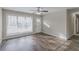 Bright living room with large windows, wood-look flooring, and a ceiling fan at 1347 Peggy Nw Ln, Conyers, GA 30012