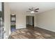 Open-concept living room with wood-look flooring, a ceiling fan, and a view of the kitchen at 1347 Peggy Nw Ln, Conyers, GA 30012
