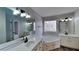 Updated bathroom featuring double vanities, a soaking tub, and decorative window at 1745 Wynfield Ln, Auburn, GA 30011