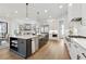 Modern kitchen with white and gray cabinets, an island with a sink, and stainless appliances at 13385 Bishops Ct, Roswell, GA 30075