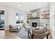 Living room with a stone fireplace, plush seating, and a view of the screened porch at 13385 Bishops Ct, Roswell, GA 30075