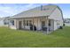 Back exterior of house with patio, furniture, and grassy yard at 185 Hollis St, Fayetteville, GA 30215