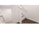 Indoor carpeted staircase with hardwood flooring below at 989 Cades Walk # 144, Lawrenceville, GA 30045