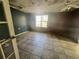 Empty bedroom with tile flooring, teal and mauve walls, and window at 202 Hayes St, Villa Rica, GA 30180