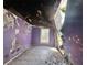 Damaged bedroom with purple walls, tile floor, and exposed ceiling at 202 Hayes St, Villa Rica, GA 30180