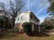 Side view of a two-story home with brick and siding exterior and landscaping at 517 Fond Du Lac Dr, Stone Mountain, GA 30088