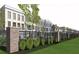 Townhome community with brick and iron fence, landscaping, and green space at 531 S Main St # 210, Alpharetta, GA 30009