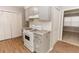 Renovated kitchen highlighting gray cabinets, granite countertops, white appliances, and wood-look flooring at 2579 Sweetridge Ct, Lithia Springs, GA 30122