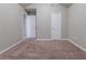 Empty bedroom with carpeted floors, white door, and vaulted ceilings at 5901 Bluegrass Vw, Fairburn, GA 30213