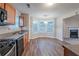 Eat-in kitchen with wood cabinets, black appliances, and bay window at 5901 Bluegrass Vw, Fairburn, GA 30213