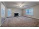 Living room with fireplace, ceiling fan, and plush carpet, open to adjacent areas at 5901 Bluegrass Vw, Fairburn, GA 30213