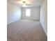 Spacious main bedroom with neutral-colored carpeting and plenty of natural light at 10 Barton Ln, Covington, GA 30016