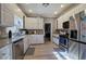 Bright kitchen with white cabinets, stainless steel appliances, and granite countertops at 3634 Autumn Ridge Pkwy, Marietta, GA 30066