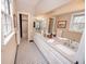 Double vanity bathroom with granite countertops and black and white tile floor at 210 Jeanette St, Canton, GA 30114