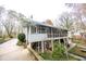 Rear view of house showcasing a large screened porch and brick accents at 210 Jeanette St, Canton, GA 30114