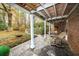 Relaxing flagstone patio with wooden covered area, wicker chair, and view of backyard at 210 Jeanette St, Canton, GA 30114