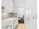 Bright butler's pantry with white cabinetry, quartz countertops, and a view to the dining area at 4145 Morningside Dr, Cumming, GA 30041