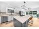 Updated kitchen featuring white cabinetry, a gray island with quartz countertop, and wood floors at 4145 Morningside Dr, Cumming, GA 30041