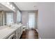 Full bathroom with white vanity, toilet, shower, and wood-look flooring at 682 Jockey Ln, Auburn, GA 30011