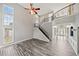 Living room with wood-look floors, ceiling fan, and a view of the foyer and staircase at 305 Haley Cir, Atlanta, GA 30349