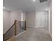 Upstairs hallway with wooden railing, carpeted floors, and two white doors at 454 Boulder Crest Trl, Villa Rica, GA 30180