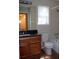 Bathroom with oak vanity, granite countertop, and tiled floor at 959 Romer Pl, Stone Mountain, GA 30083