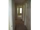 Hallway leading to bedrooms with carpeted floors and closet doors at 959 Romer Pl, Stone Mountain, GA 30083