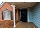 Welcoming front porch with black door and gold hardware at 1061 Shasta Ct, Jonesboro, GA 30238