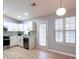 Bright and airy kitchen featuring white cabinets, stainless steel appliances, and a door leading to the backyard at 1061 Shasta Ct, Jonesboro, GA 30238