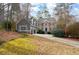 Two-story home with a basketball hoop in the driveway and surrounded by trees at 201 Rippling Nw Dr, Marietta, GA 30064