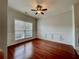 Living room with hardwood floors, chair rail molding, and large window at 2772 Sedgeview Ln, Buford, GA 30519