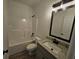 Bathroom with shower/tub combo, vanity with granite countertop, and wood-style flooring at 154 Rabon Trl, Temple, GA 30179