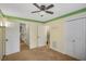 Spacious bedroom with carpet flooring, ceiling fan, and multiple doors at 4545 Canterbury Dr, Cumming, GA 30040