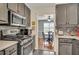 Kitchen featuring stainless steel appliances, gray cabinets, and a breakfast nook at 4545 Canterbury Dr, Cumming, GA 30040