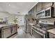 Kitchen with gray cabinets, stainless steel appliances, and a view of the adjacent living space at 4545 Canterbury Dr, Cumming, GA 30040