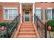 Close-up view of the brick steps and elegant front door with holiday wreath at 4754 Ivy Ridge Se Dr # 1, Atlanta, GA 30339