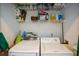 Well-lit laundry room with washer, dryer, and ample shelving at 4754 Ivy Ridge Se Dr # 1, Atlanta, GA 30339