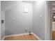 Simple laundry room with gray walls and wood-look flooring at 134 Springstead Sw Ct, Marietta, GA 30060