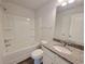 Bathroom with a shower-tub combo, granite countertop vanity, and white cabinetry at 85 Heyman Dr, Covington, GA 30016