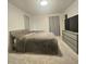Main bedroom with gray carpeting, a gray bed, and a gray dresser at 1393 Bolton Nw Rd, Atlanta, GA 30331