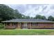 Brick ranch home with solar panels, a front porch, and a landscaped yard at 1393 Bolton Nw Rd, Atlanta, GA 30331