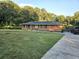 Brick ranch home with solar panels, a concrete driveway, and a large green lawn at 1393 Bolton Nw Rd, Atlanta, GA 30331